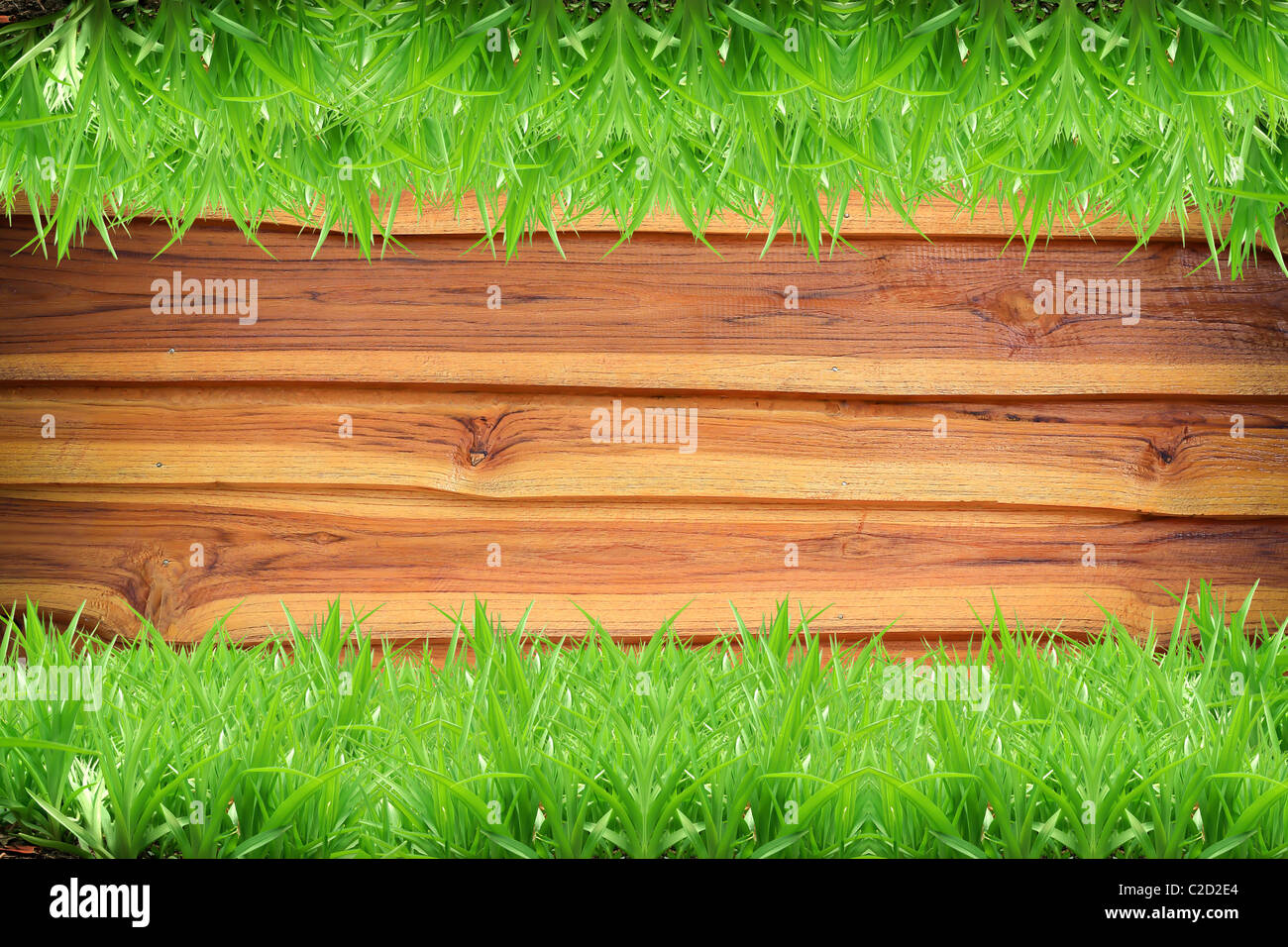 Fresh green grass on Wood background Stock Photo - Alamy