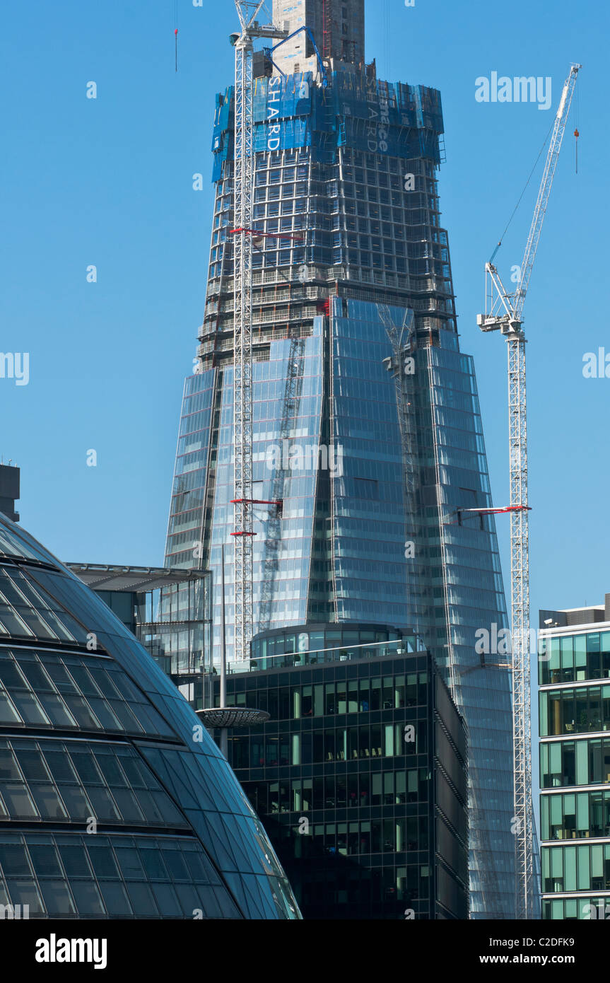 The Shard building under construction seen to the rear of the City Hall. London. England. Stock Photo