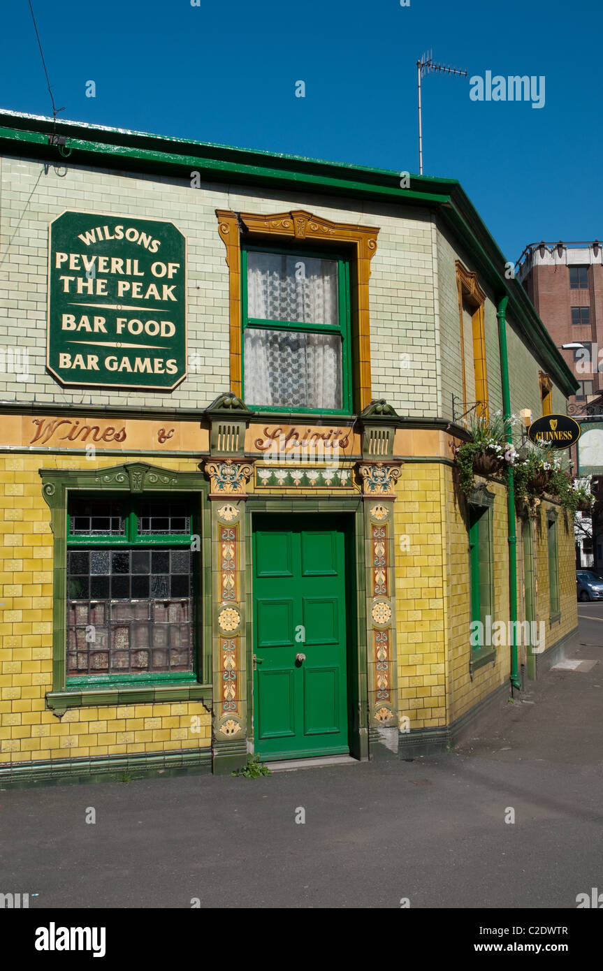 Peveril of the Peak the brightly tiled clad Victorian pub is a popular watering hole in Manchester city centre. Stock Photo