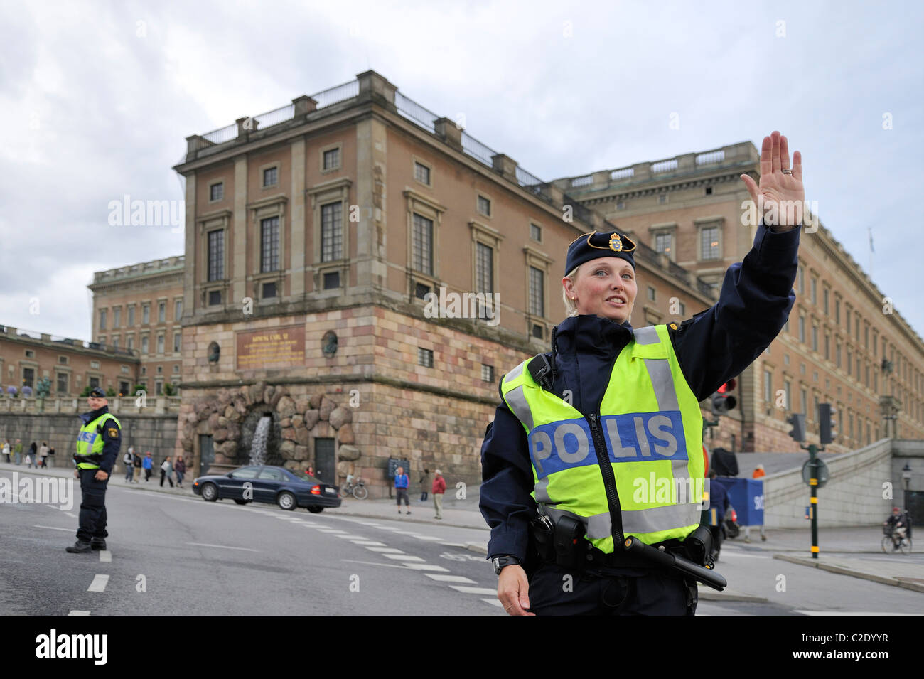 Policewoman regulating the traffic at the Stockholm Palace, Stockholms Lan, Sweden Stock Photo