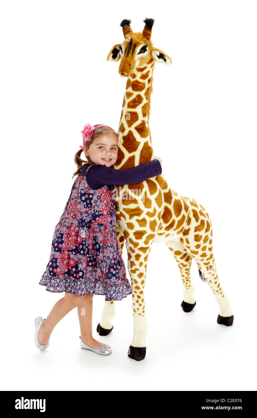 Little girl playing with stuffed giraffe toy Stock Photo