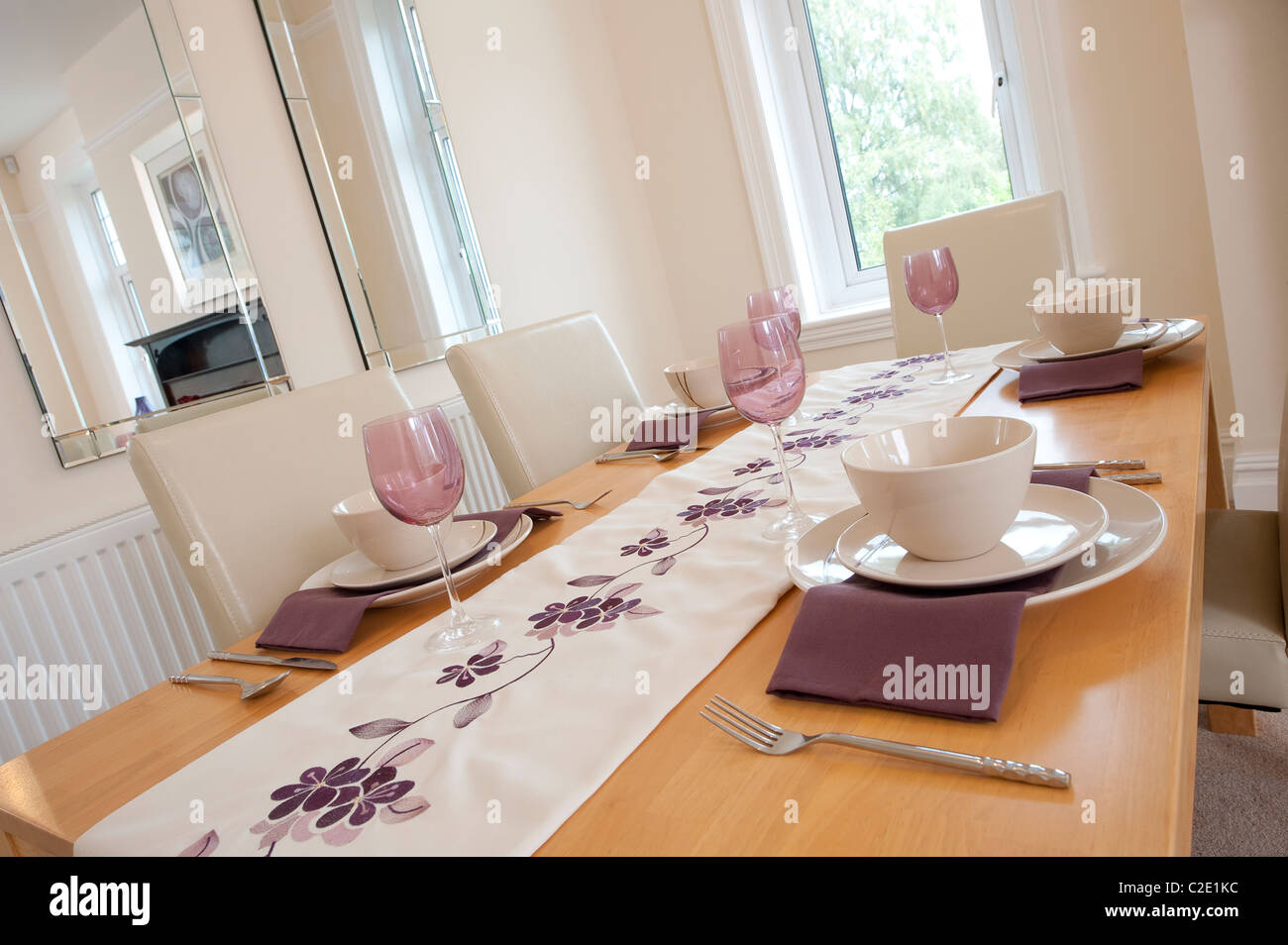 Dining table set for dinner in a beautiful modern dining room Stock