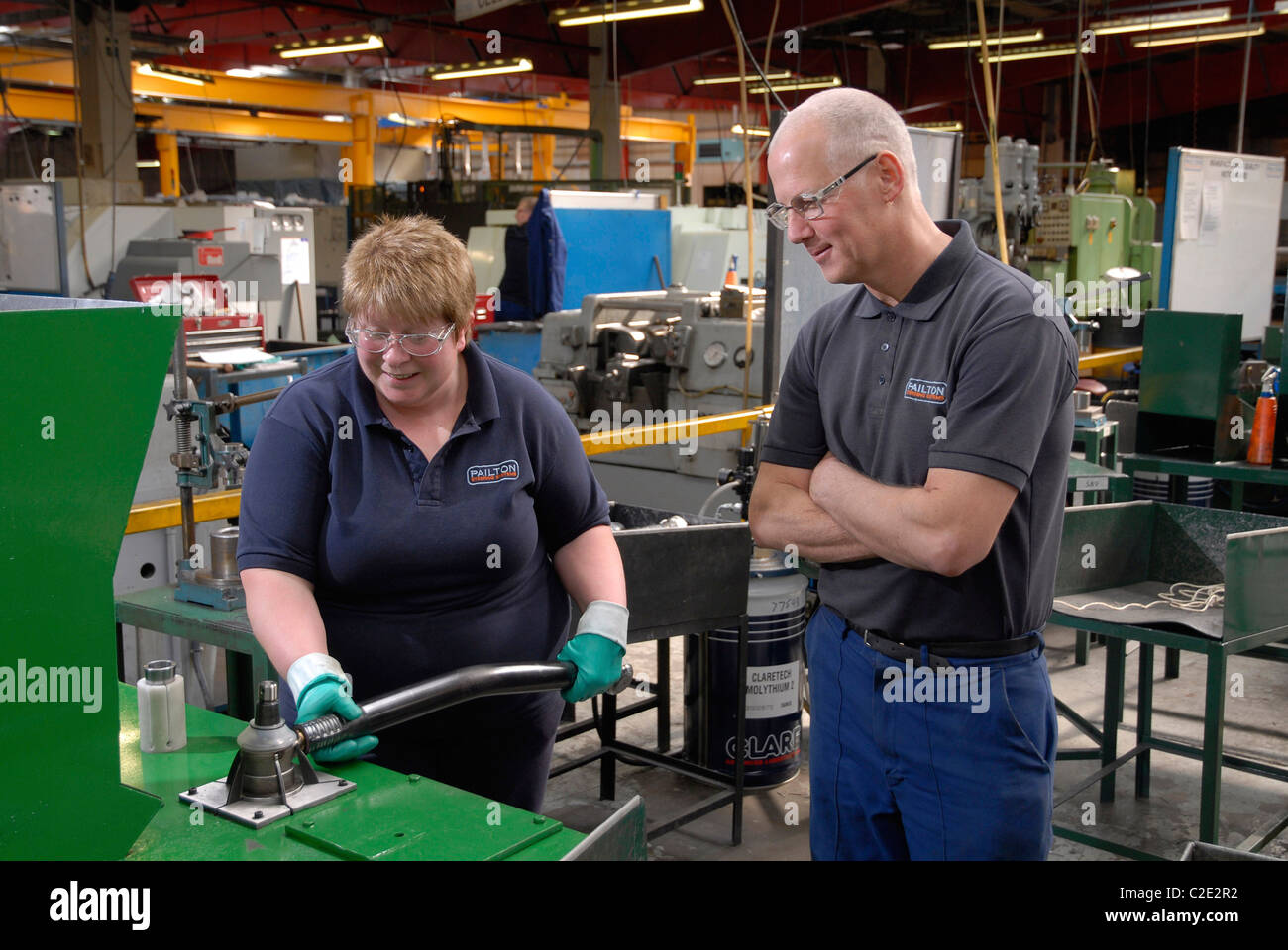 Assembly worker Sandra Hopkins and toolmaker Kevin Jordan assembling a drag link to fit the american military Oshkosh vehicle Stock Photo