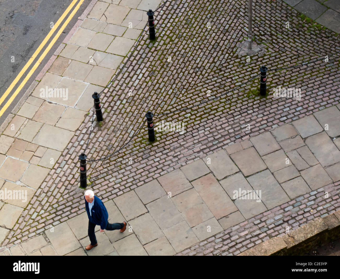 View looking down on  male pedestrian walking down a street in the UK Stock Photo