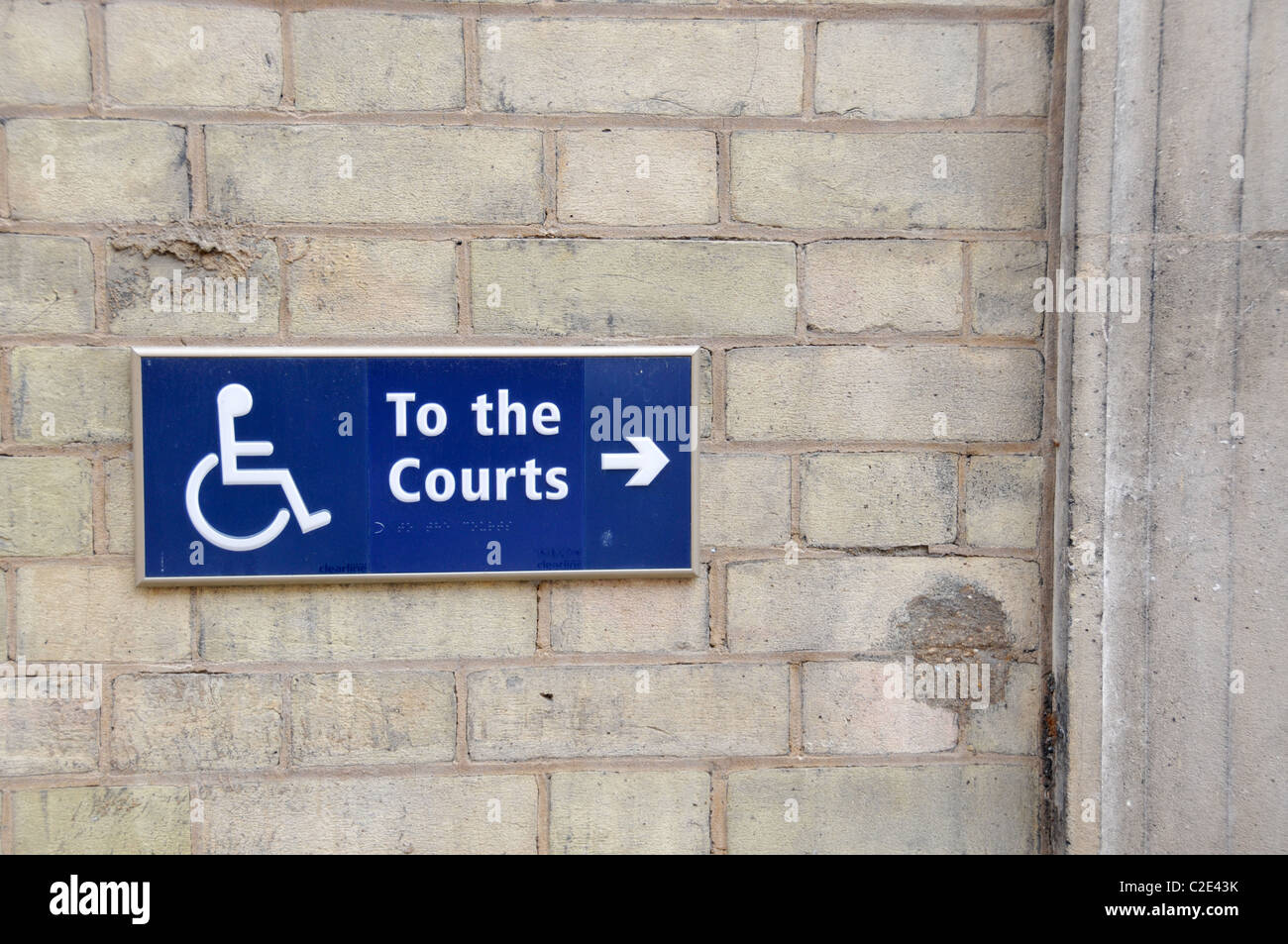 Disabled wheelchair sign pointing to the courts direction Stock Photo ...