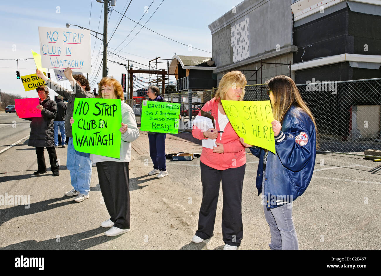 APR 9, 2011 - WANTAGH, NY: Protesters with signs against strip club allegedly being built there, Sunrise Highway, Long Island NY Stock Photo