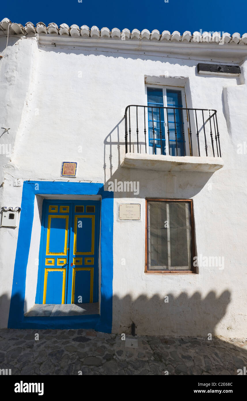 Macharaviaya, Malaga Province, Spain; House With Blue And Yellow Door Stock Photo