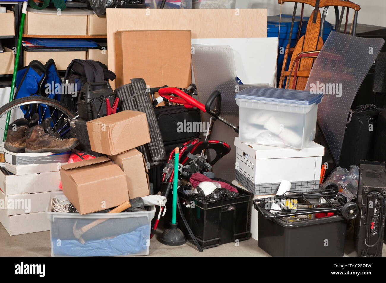 Pile of boxes junk inside a residential garage. Stock Photo