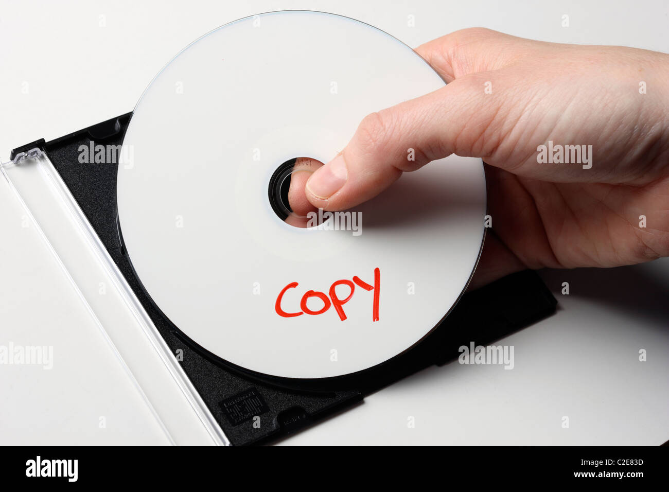 Hand halts a digital CD, DVD and cover. Digital data storage. Stock Photo