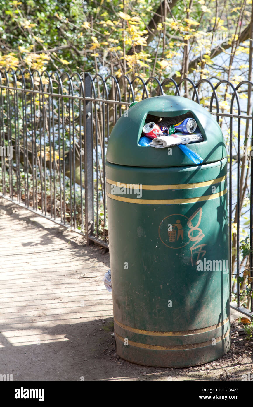 An overflowing litter bin in a park in England UK Stock Photo Alamy