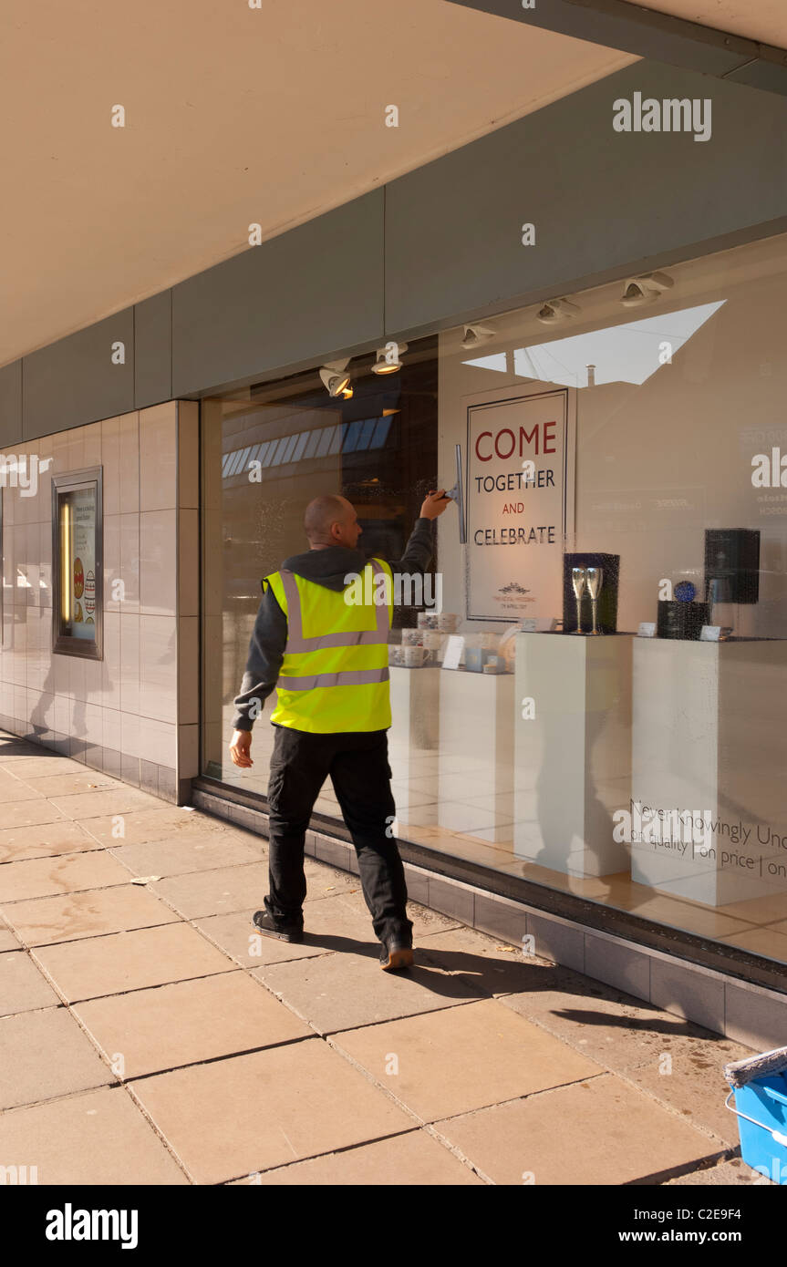 A window cleaner cleans the windows at John Lewis shop store in Norwich