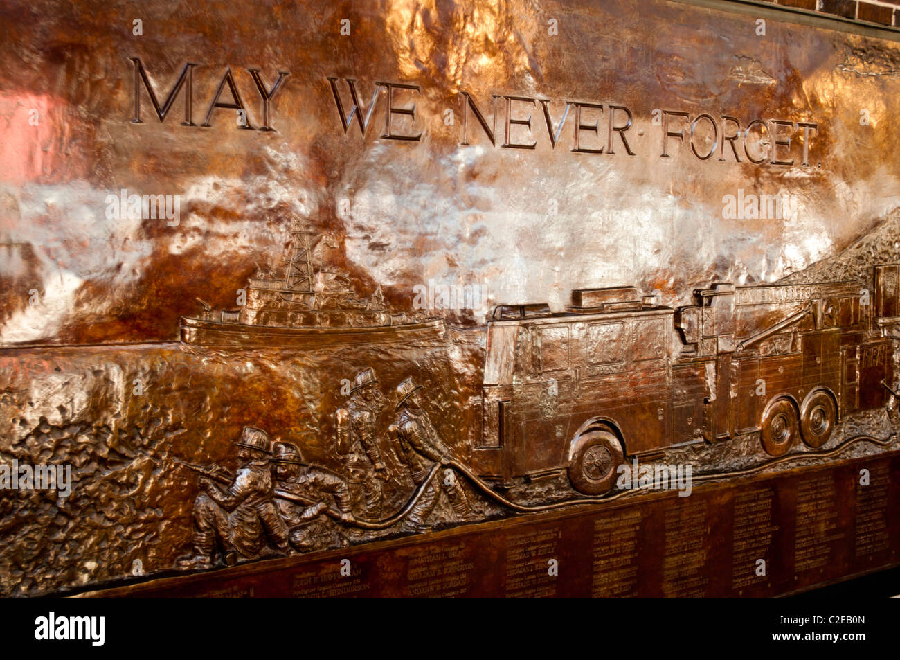 Ground Zero, May we never forget sign of New York Fire Department NYFD Memorial Wall bronze bass-relief, Manhattan, New York Stock Photo