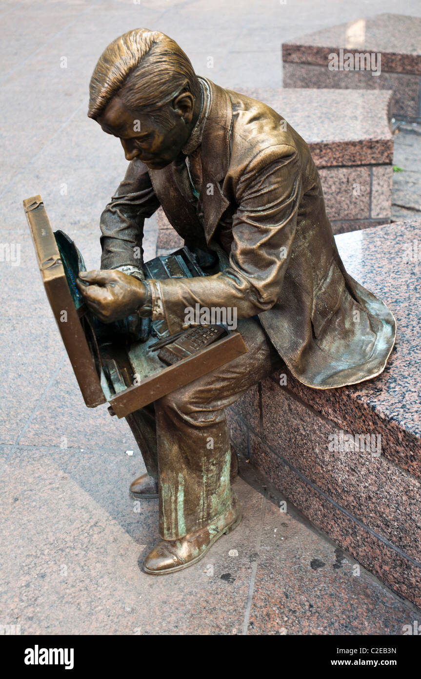 Double Check, a bronze businessman statue sitting on a bench, by John