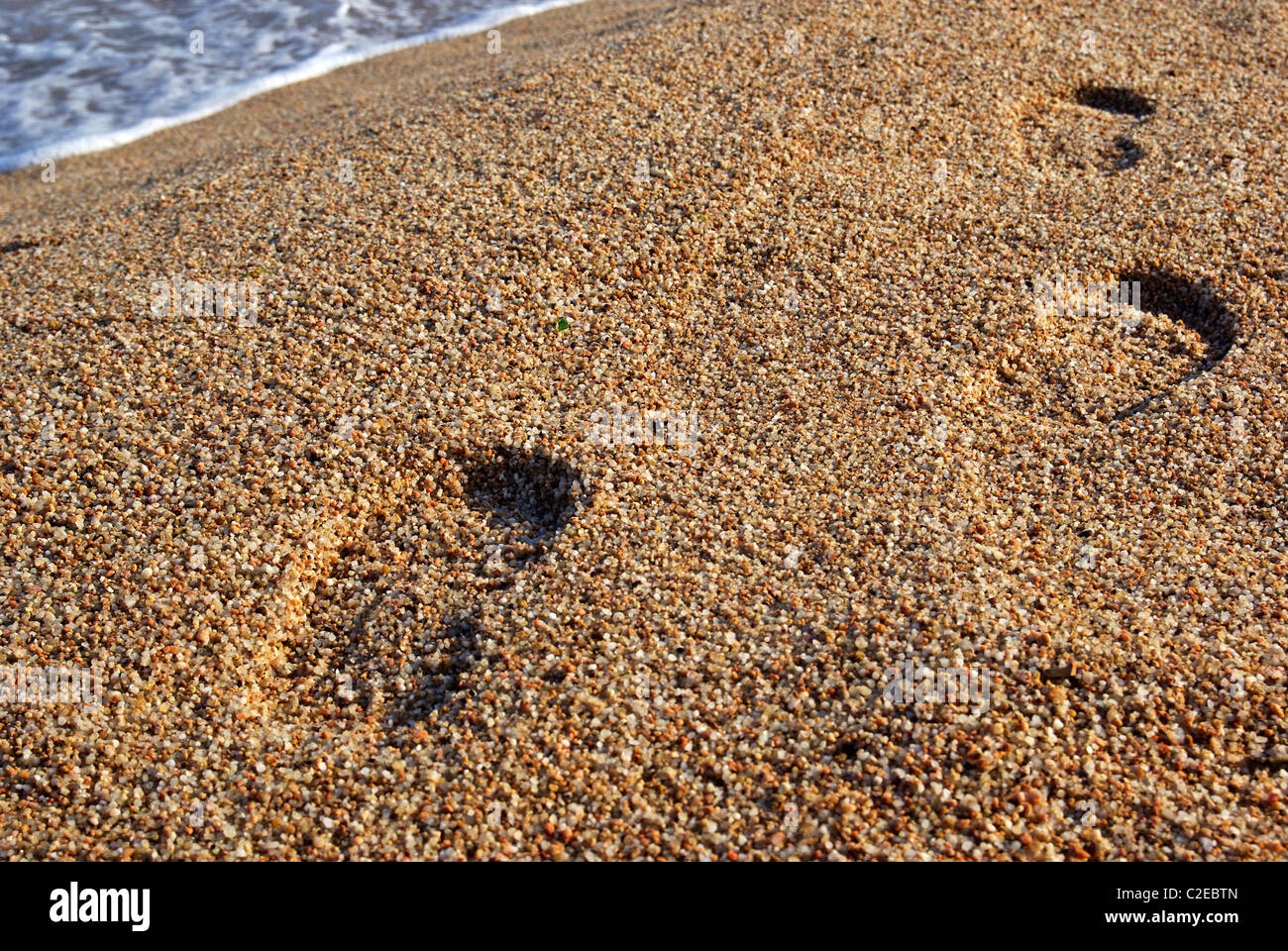 Foot prints on the mediterranean beach. Sunset time. As backdrop or background. Stock Photo