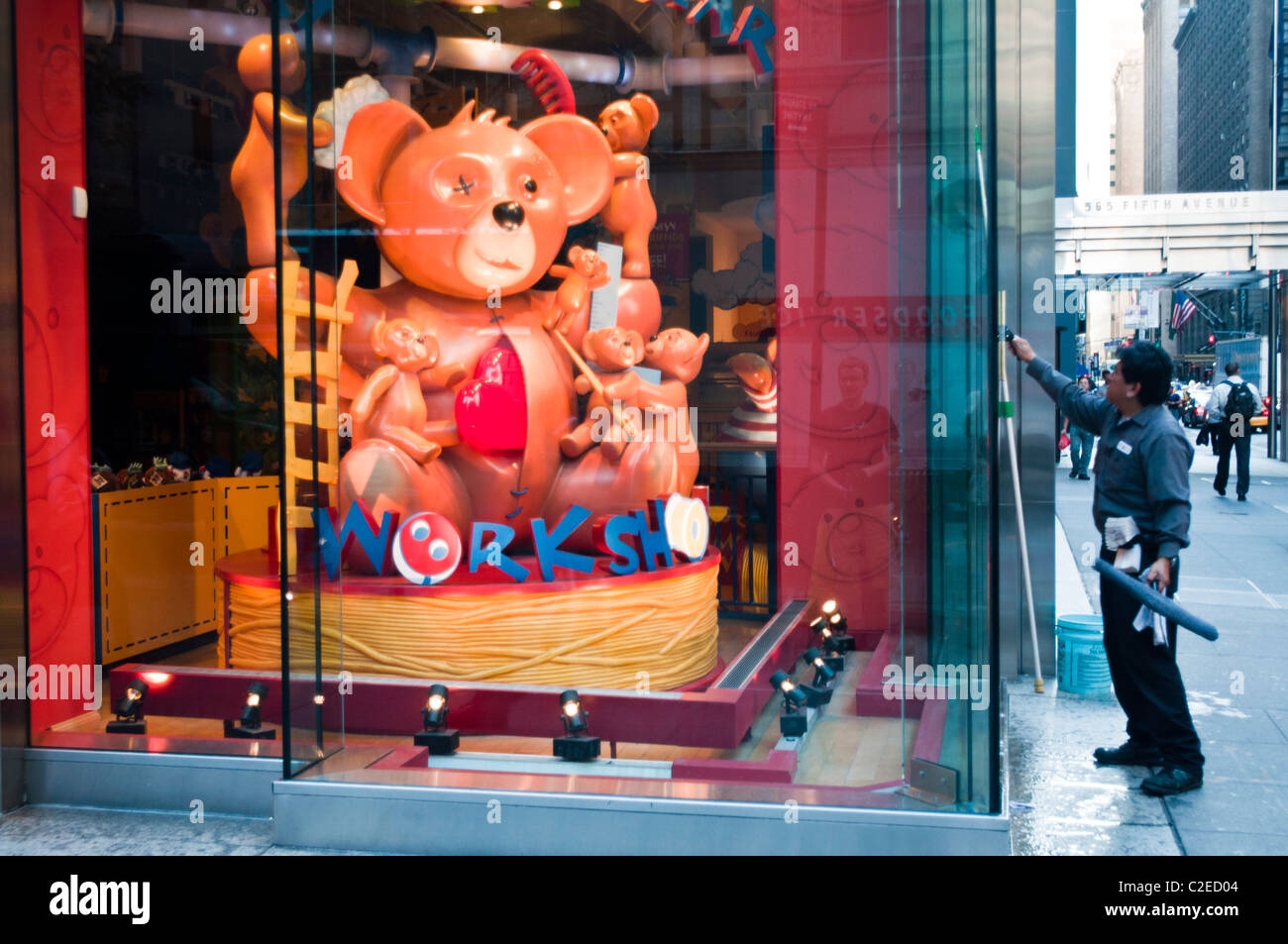Man cleaning window of Build-A-Bear Workshop at Fifth Avenue, Manhattan, New York City, USA Stock Photo