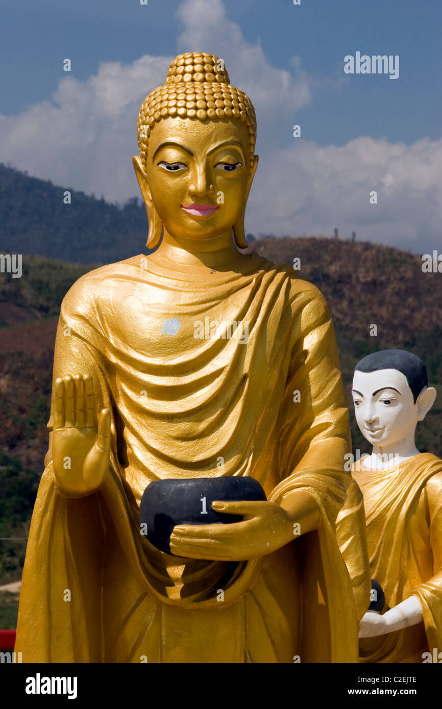 A row of tall gold Buddhist statues are on display at a beautiful