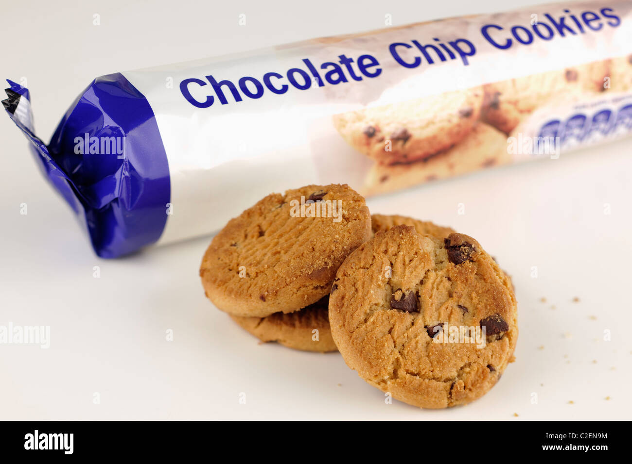 Open packet and a pile of chocolate chip cookies Stock Photo