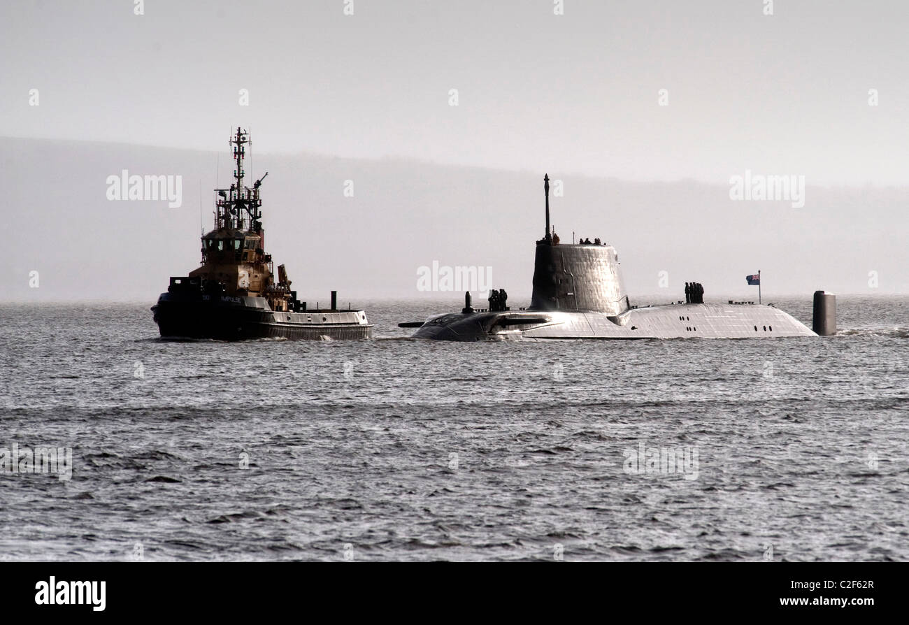 HMS Astute, the Royal Navy's latest nuclear submarine sail up Gareloch on the Firth of Cylde to her new base at HMNB Faslane. Stock Photo