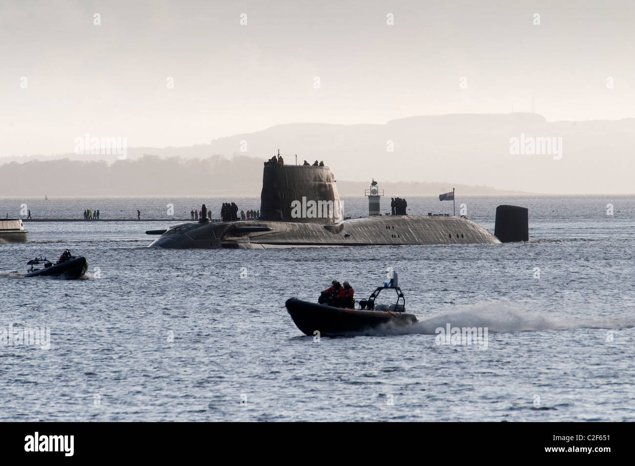 HMS Astute, the Royal Navy's latest nuclear submarine sail up Gareloch on the Firth of Cylde to her new base at HMNB Faslane. Stock Photo