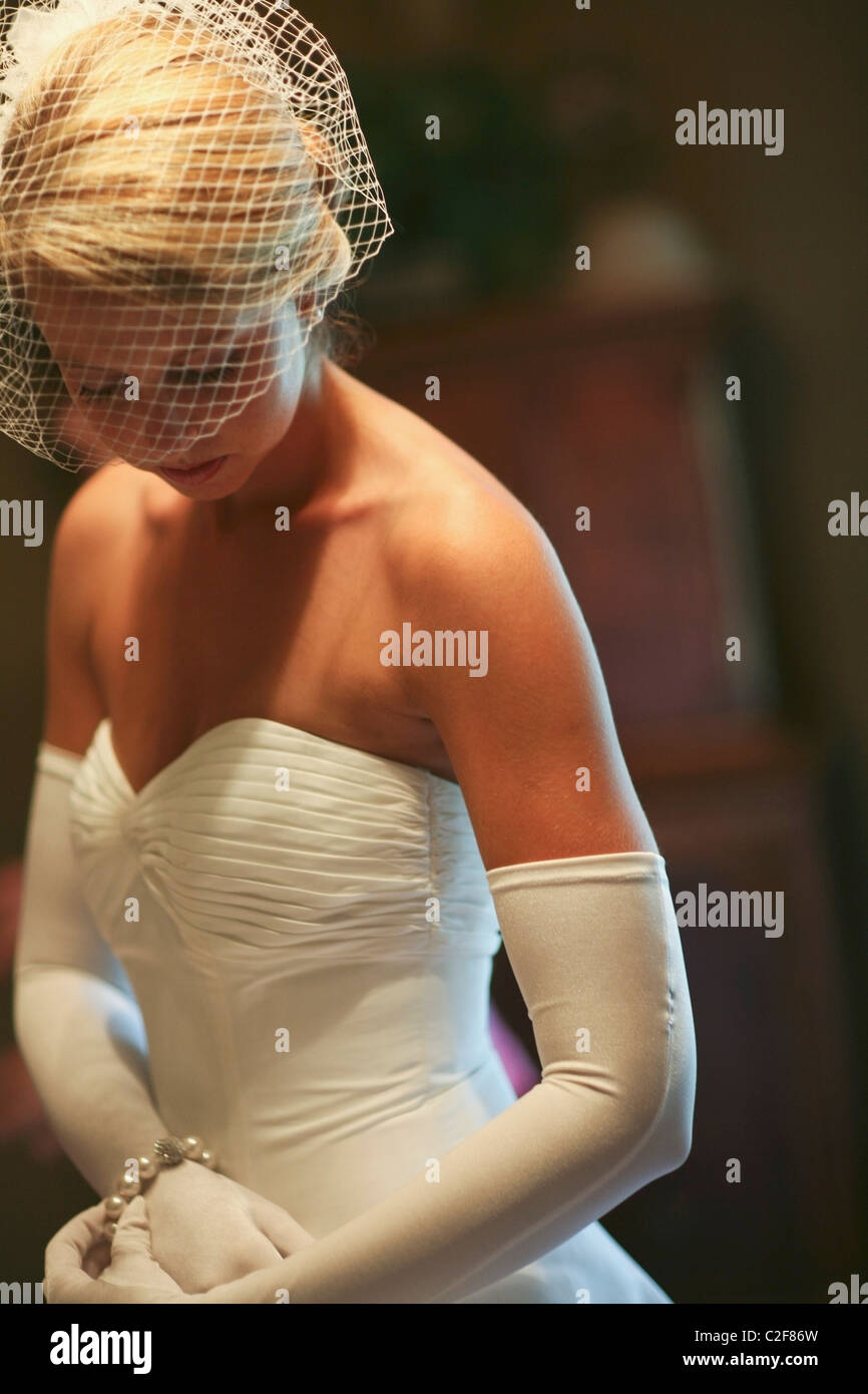 A Bride Wearing A Strapless Dress, Long White Gloves And A Veil Stock Photo  - Alamy
