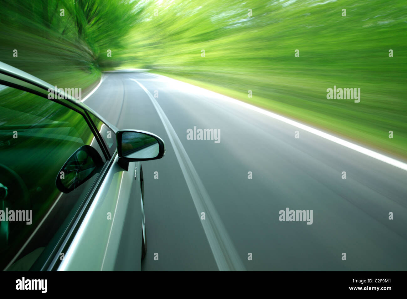 car driving fast into forest Stock Photo - Alamy