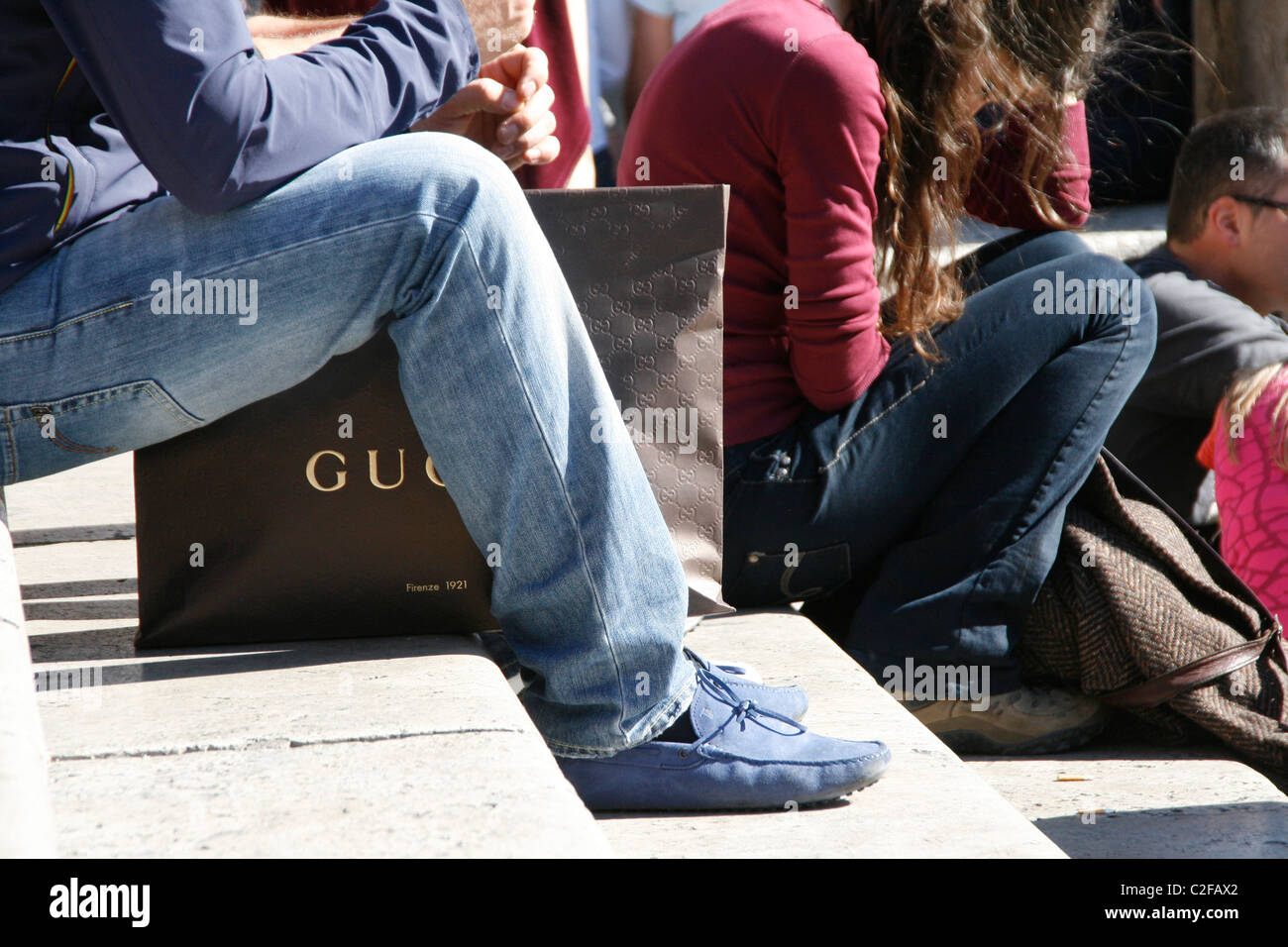 man with gucci shopping bag on the spanish steps in rome italy Stock