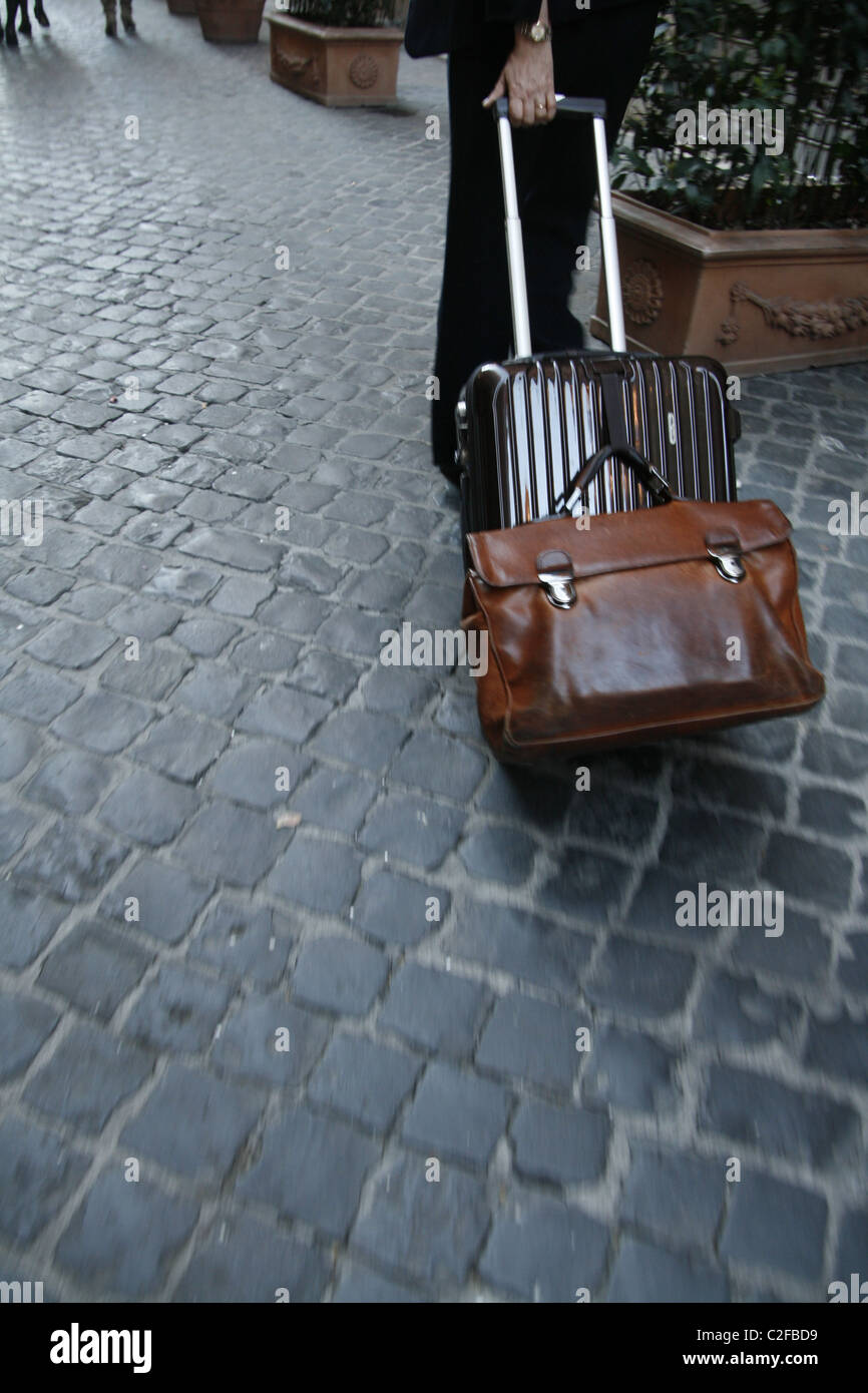 businessman pulling trolley case in street road in rome italy Stock ...