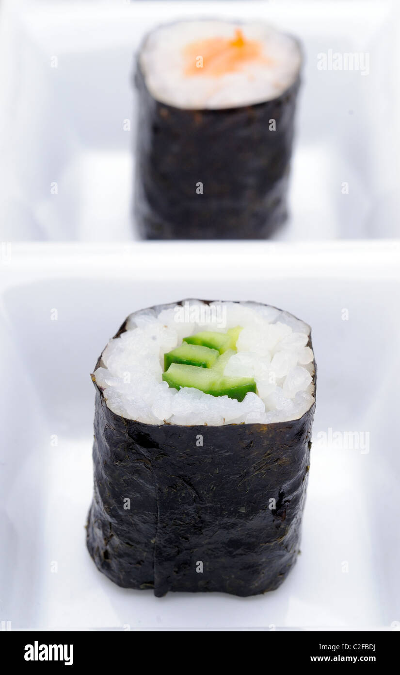 Two Kappa Maki Japanese Cucumber And Salmon Sushi Rolls With Black Seaweed On A White Dish Stock - Alamy