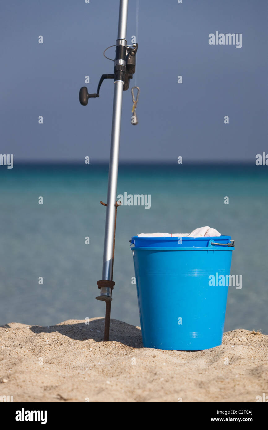Fishing rod and buckets on beach Stock Photo - Alamy