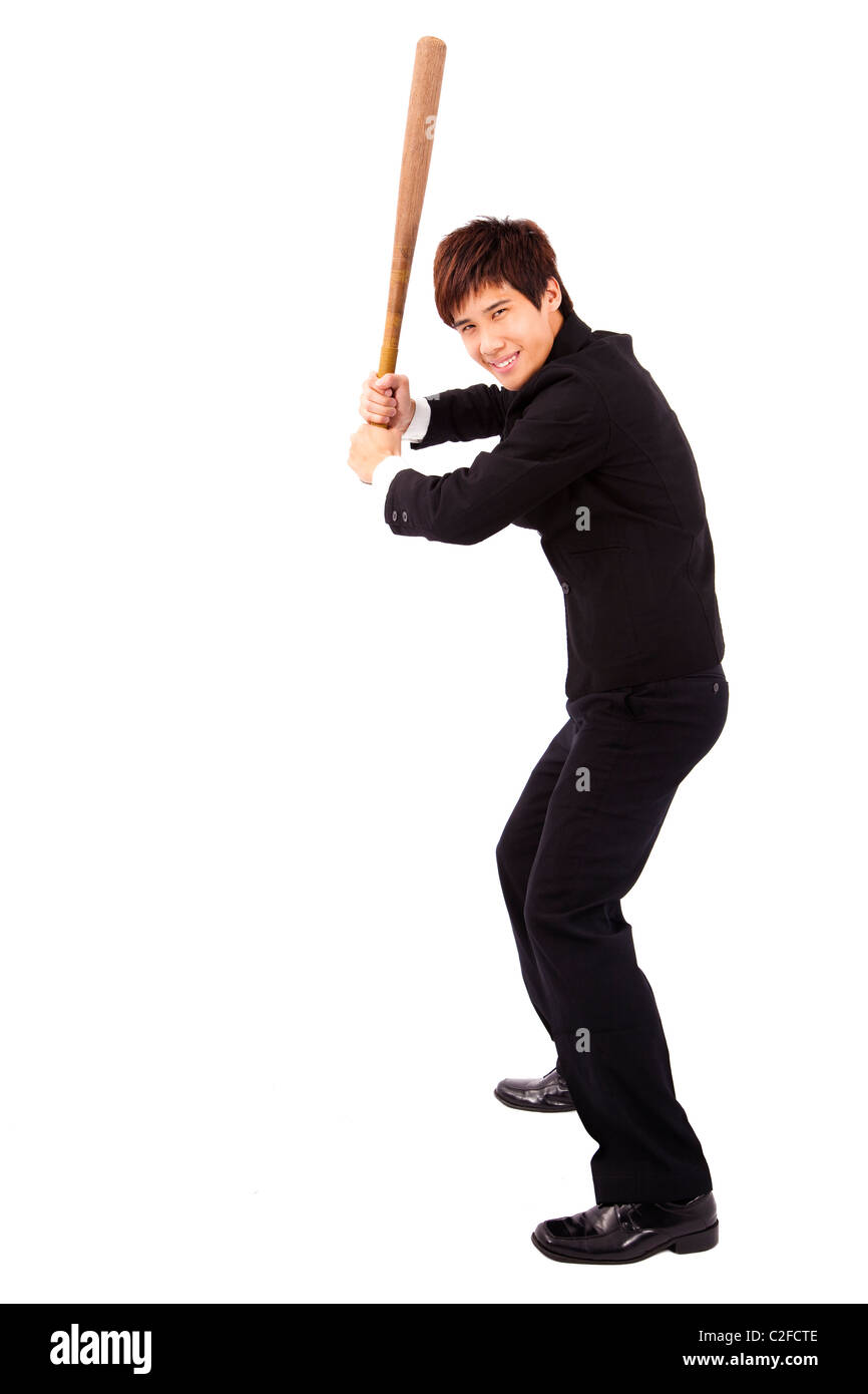 young and confident businessman holding a baseball bat preparing to strike Stock Photo