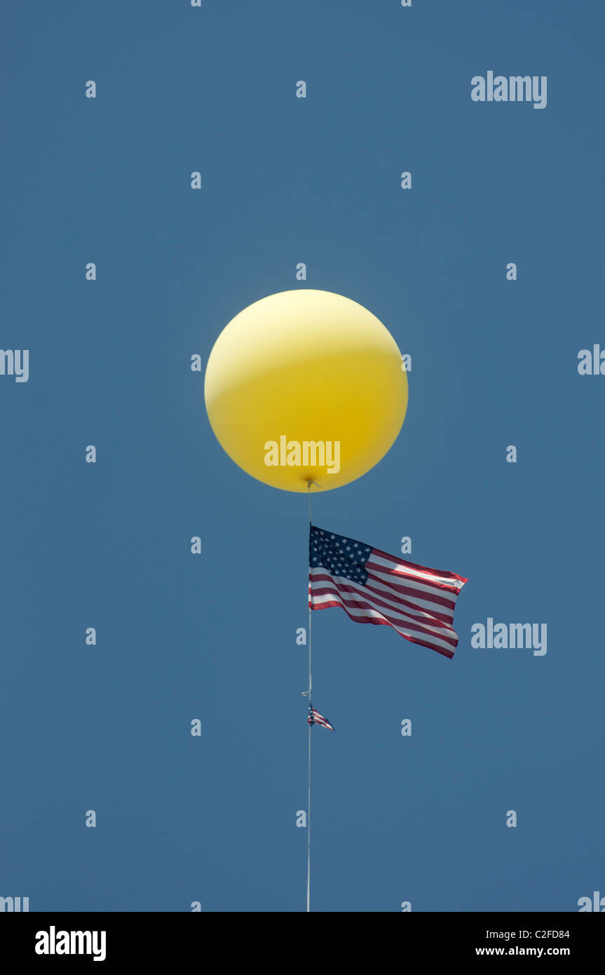 giant helium filled balloon flying the American Flag at automobile dealership Stock Photo