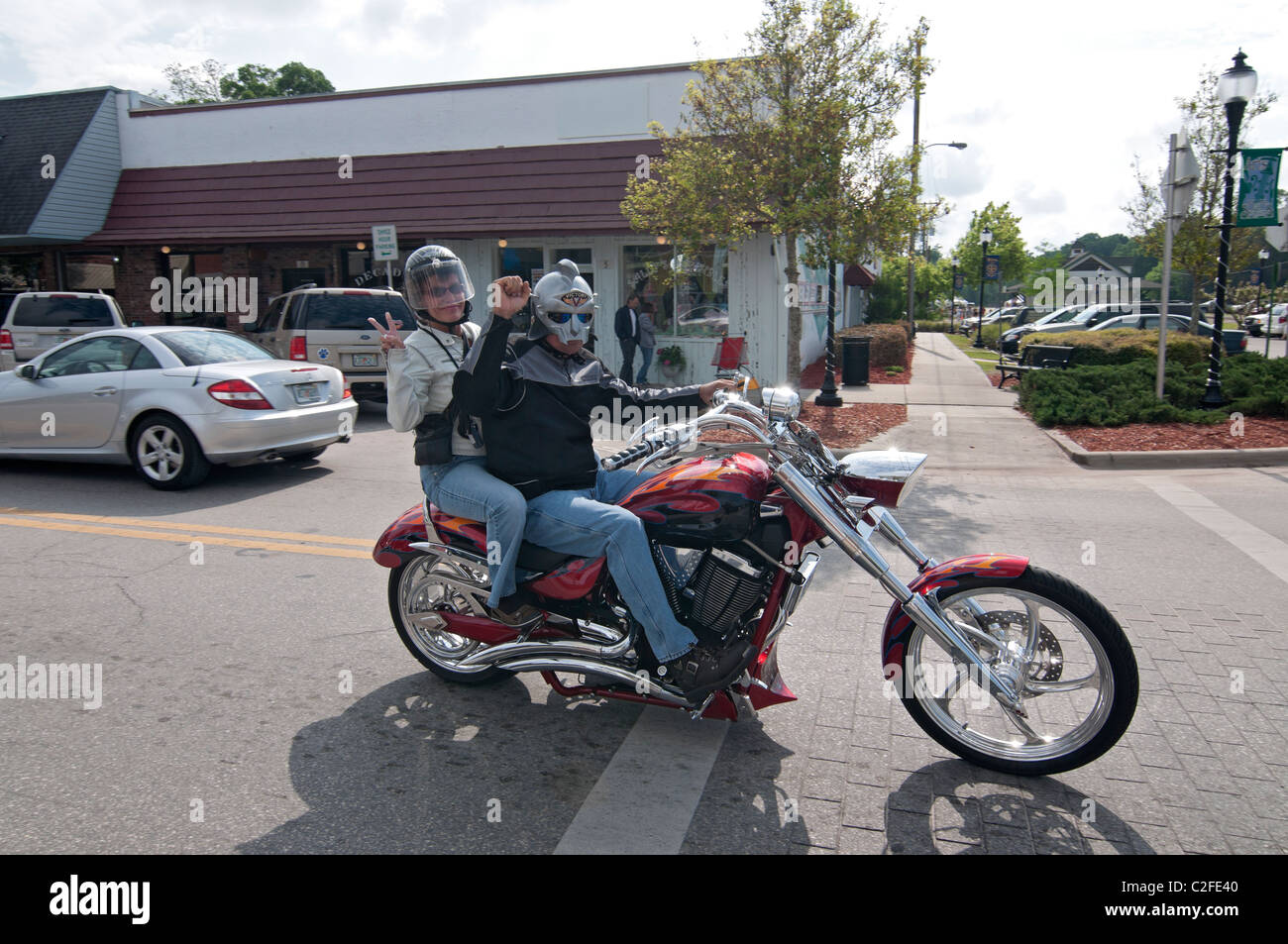 couple on motorcycle traveling through small North Florida town of High Springs Stock Photo
