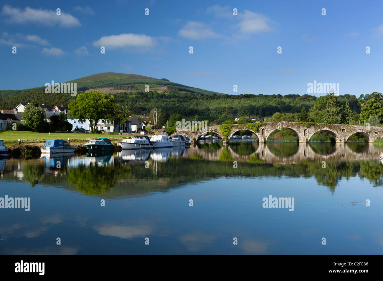 View over River Barrow from Graiguenamanagh to village of Tinnahinch, stone arched bridge and Brandon Hill Stock Photo