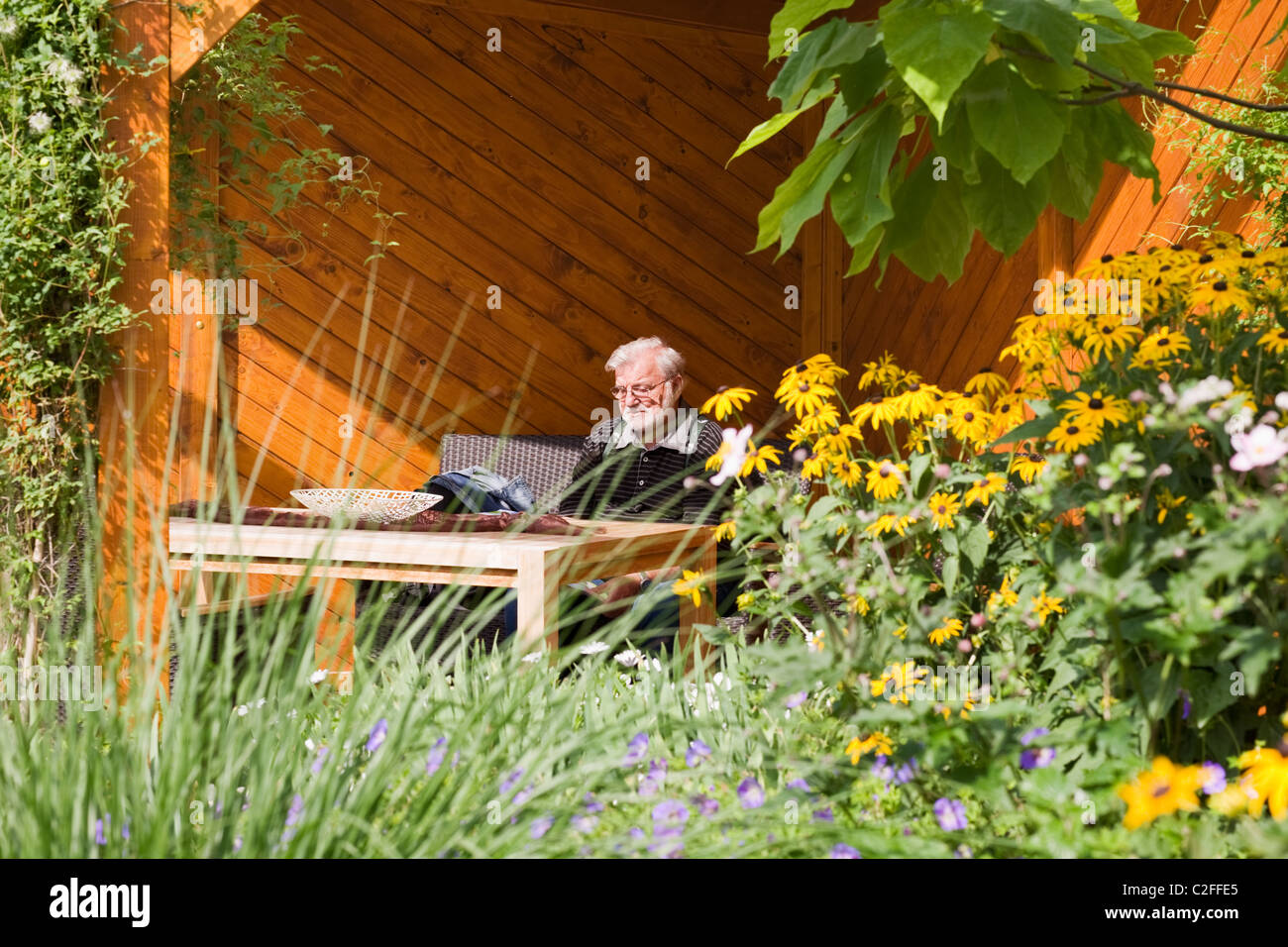 Person sitting in garden hi-res stock photography and images - Alamy