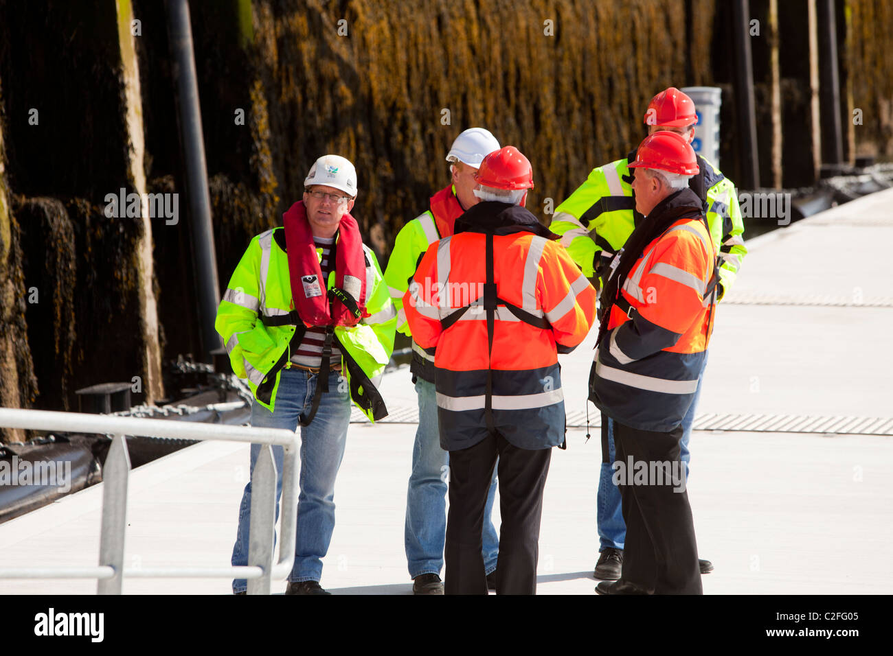 Workers waiting to be transported out to the Walney offshore wind farm at Barrow in Furness, UK. Stock Photo