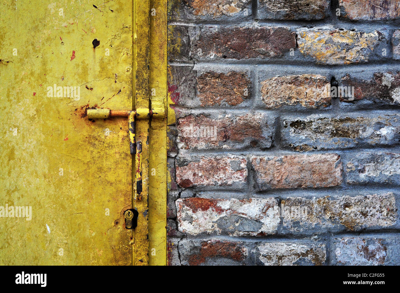 Old grunge metal doors and a brickwall detail. Stock Photo