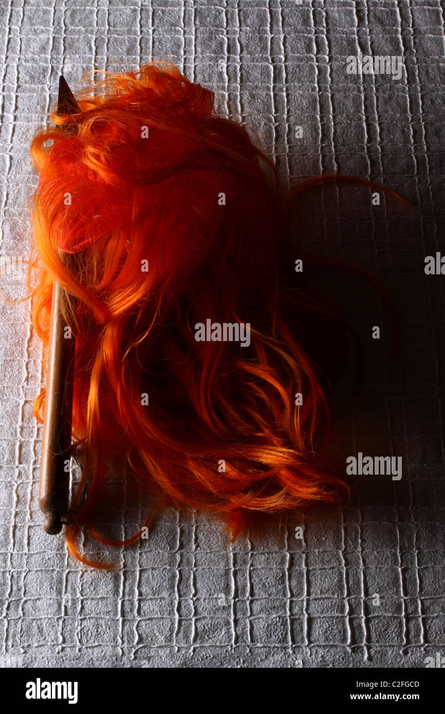 orange wig with a pick Stock Photo