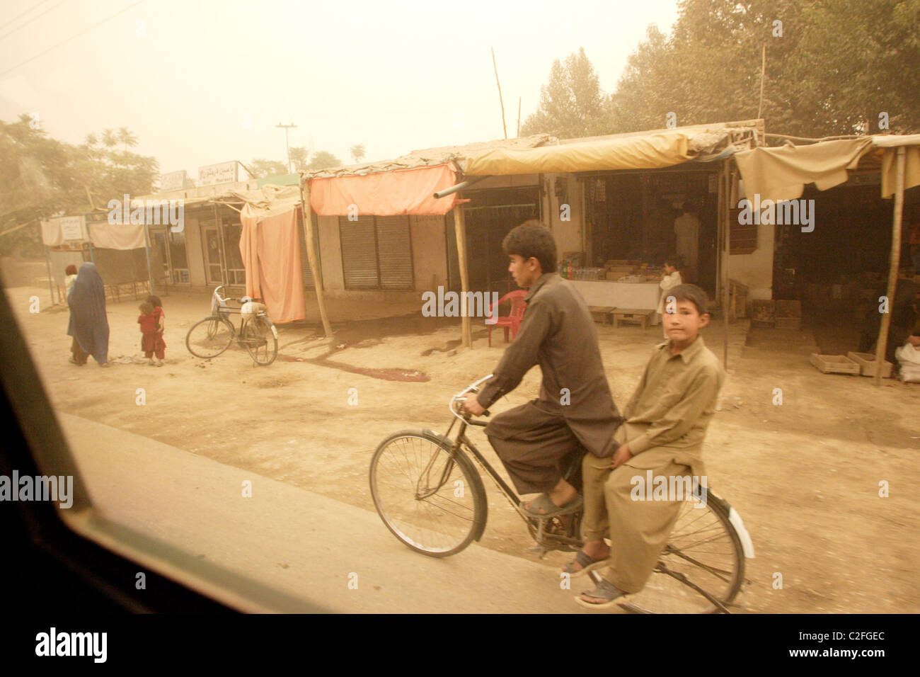 Young Afghans on a bike, Kunduz, Afghanistan Stock Photo