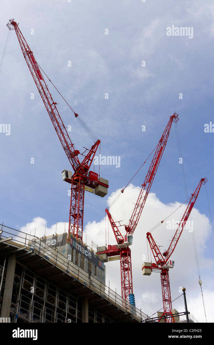 Construction cranes against a blue sky in London, England, UK Stock Photo