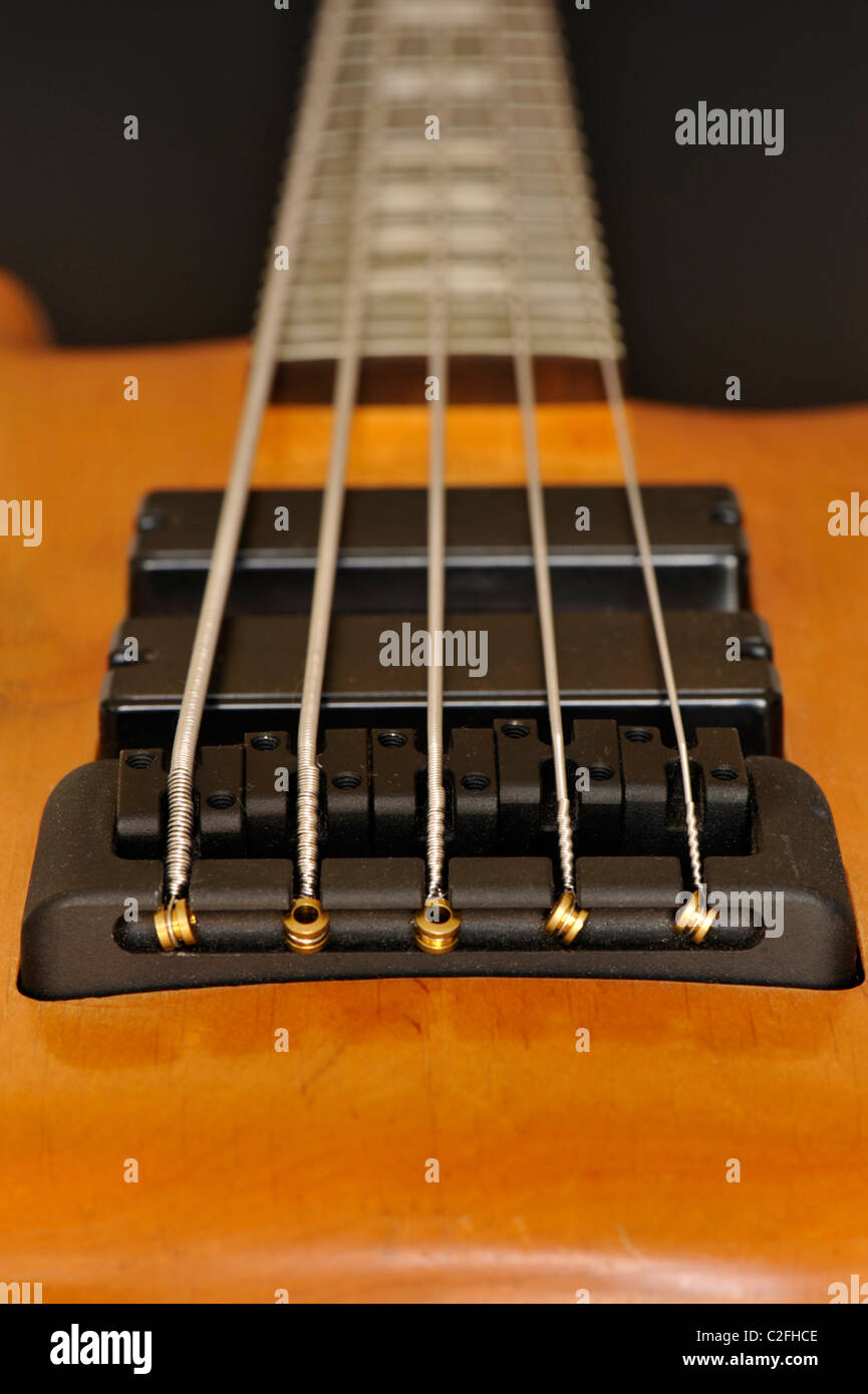 Close-up of a 5-string electric bass guitar looking along the neck from the pickups Stock Photo