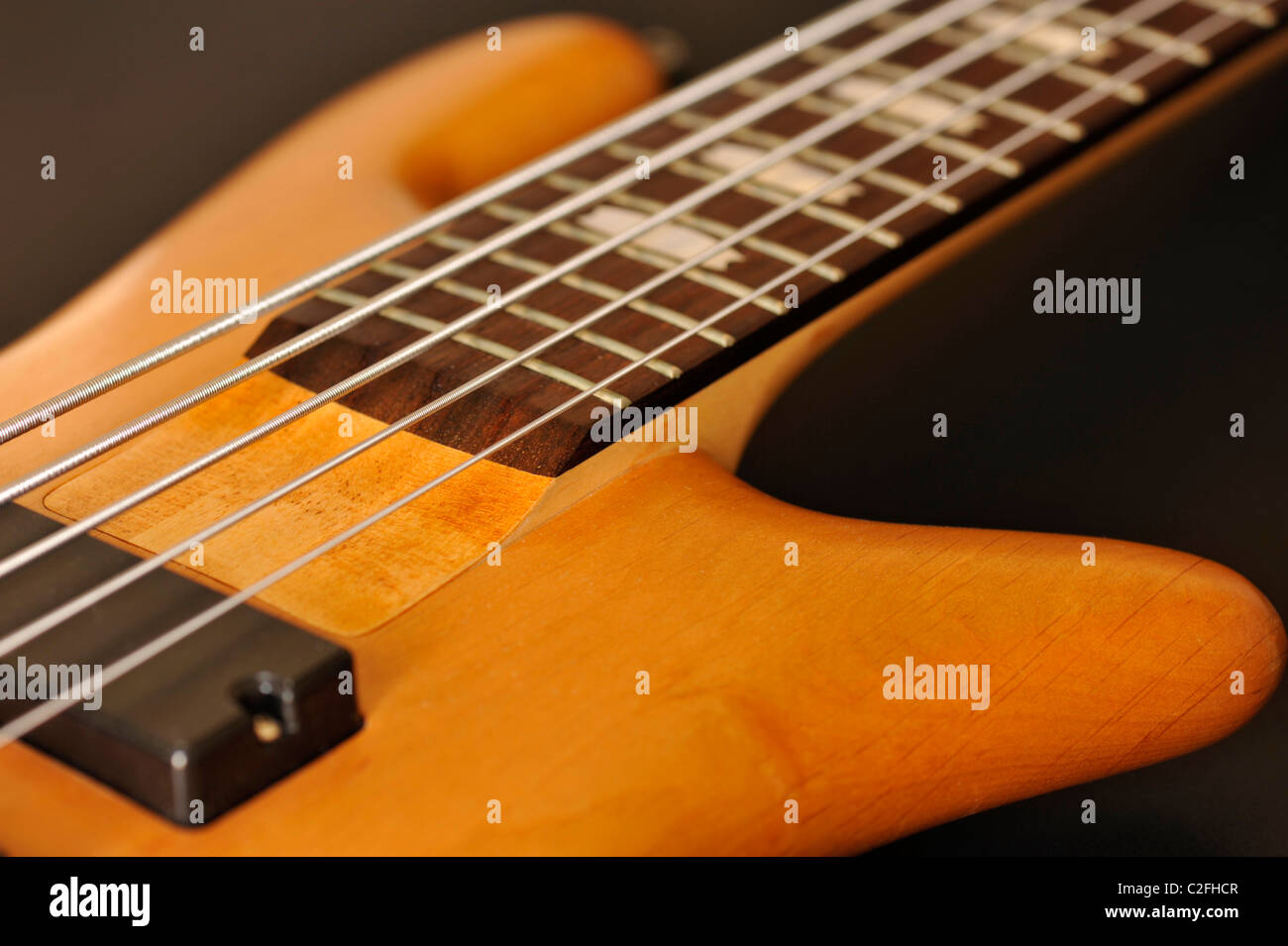 Close-up of strings and cut-away body of a 5-string electric bass guitar Stock Photo