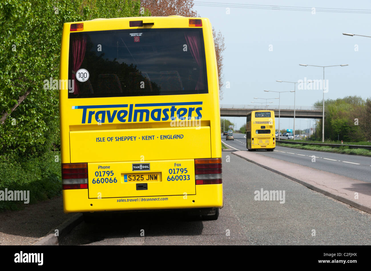 A Travelmasters coach and double-decker bus on the A2 in Kent Stock Photo