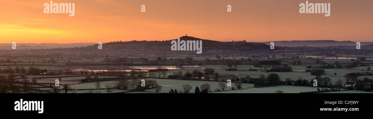 A high resolution panoramic photograph of Glastonbury Tor and the Somerset Levels on a frosty winter morning at sunrise. Stock Photo