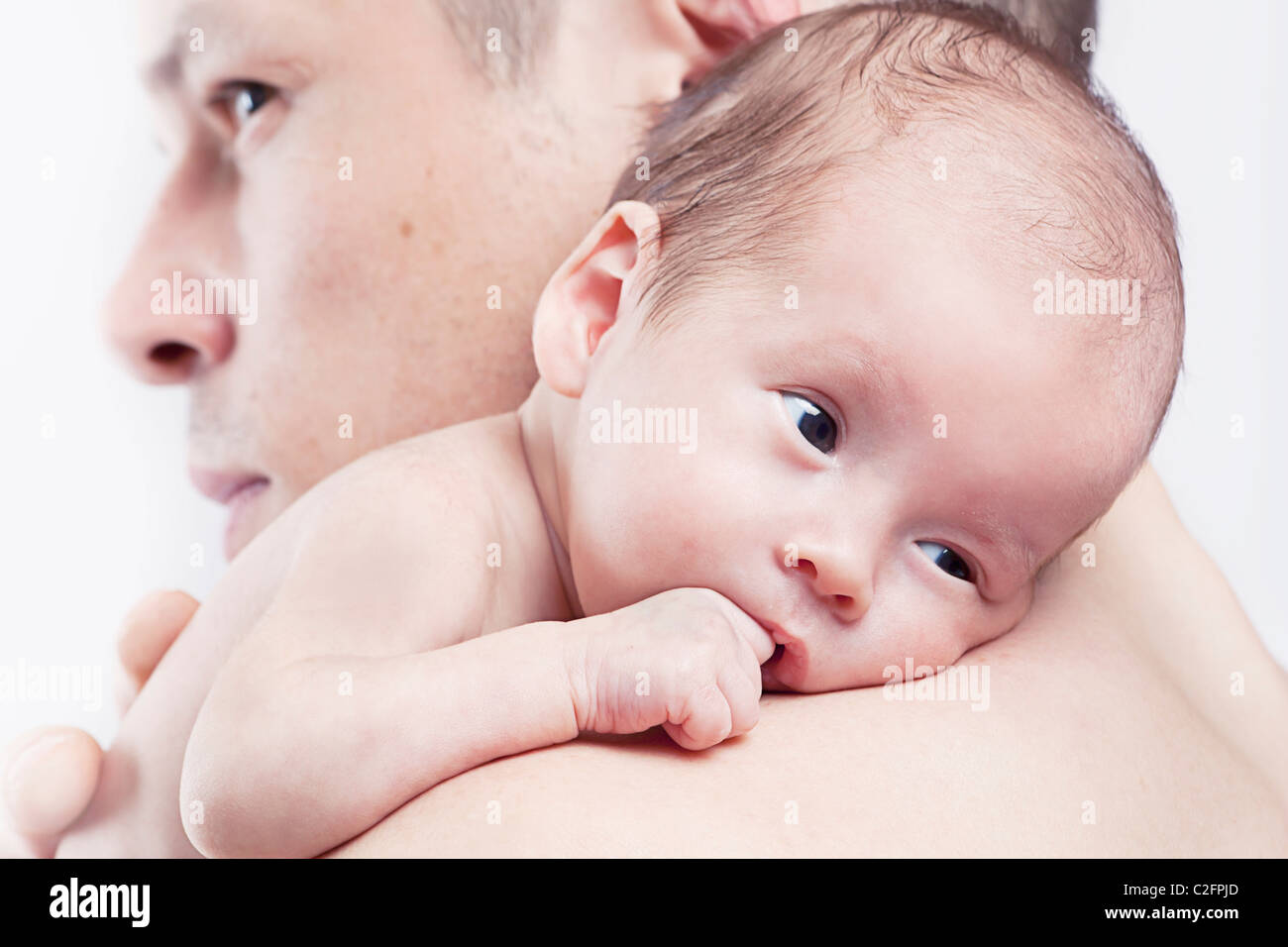 baby resting on father's shoulder Stock Photo
