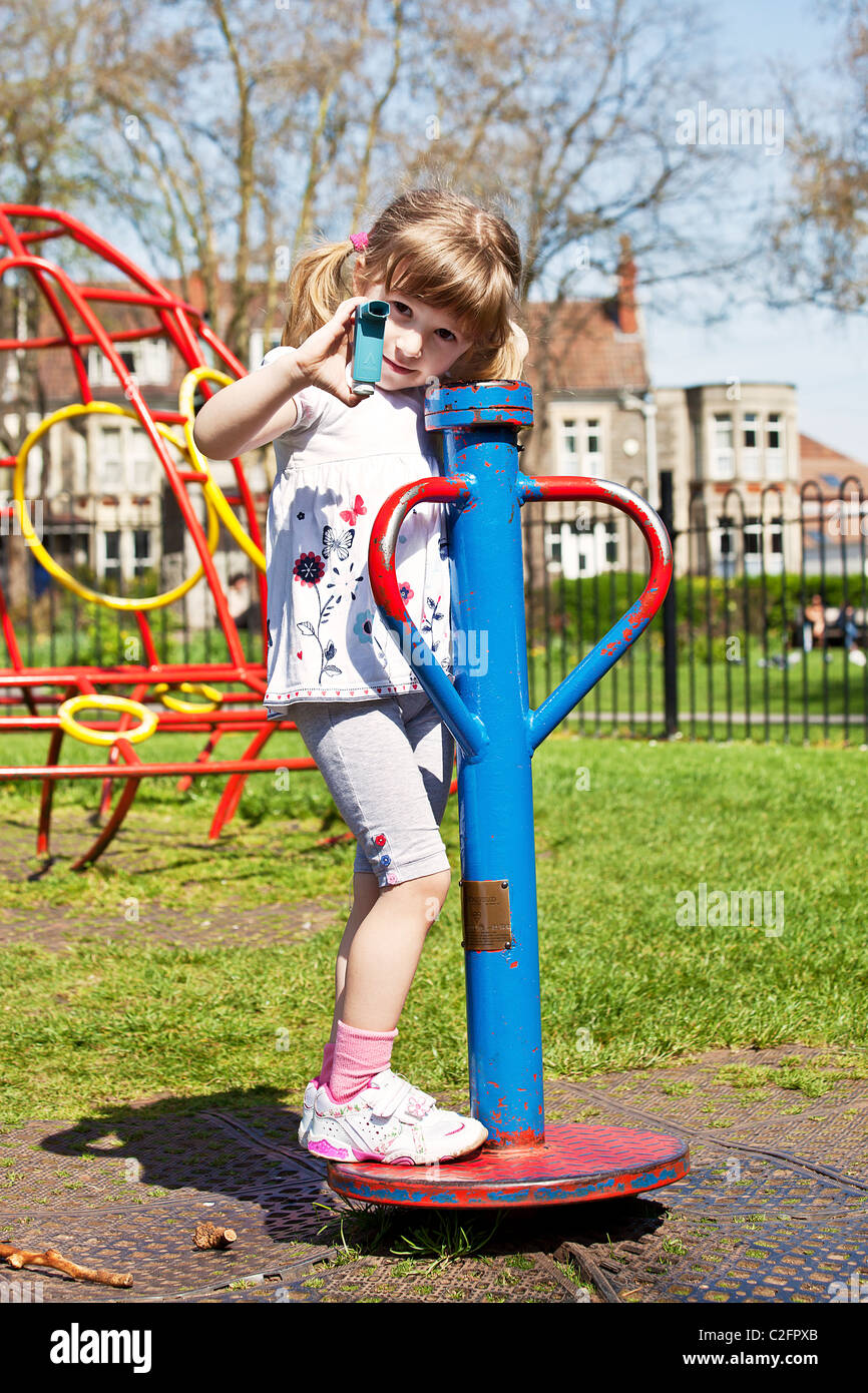 girl with inhaler on playground Stock Photo