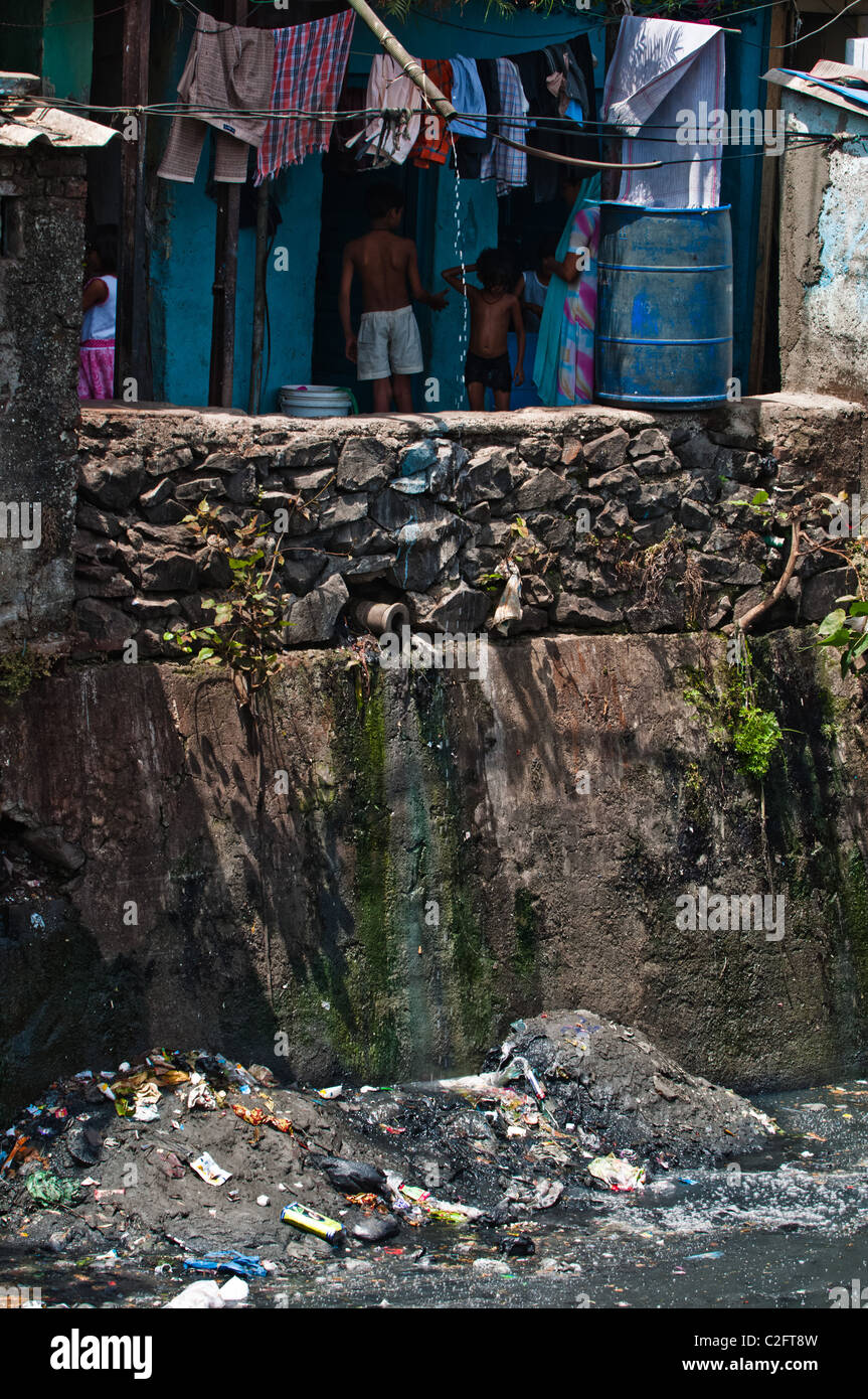 Dharavi Slum shacks above a sewage filled river Stock Photo