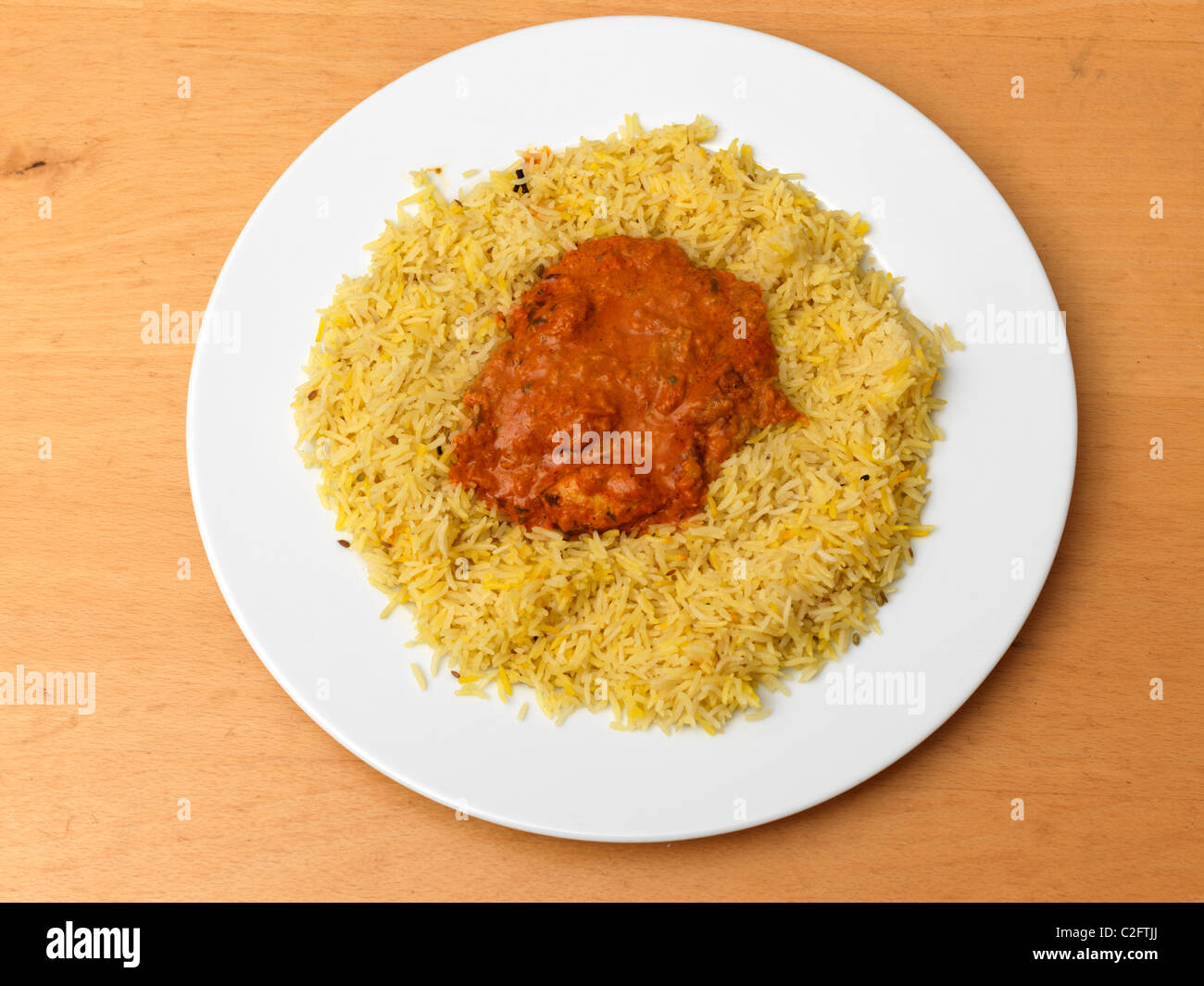 Chicken Tikka Masala And Pilau Rice On A Plate Stock Photo