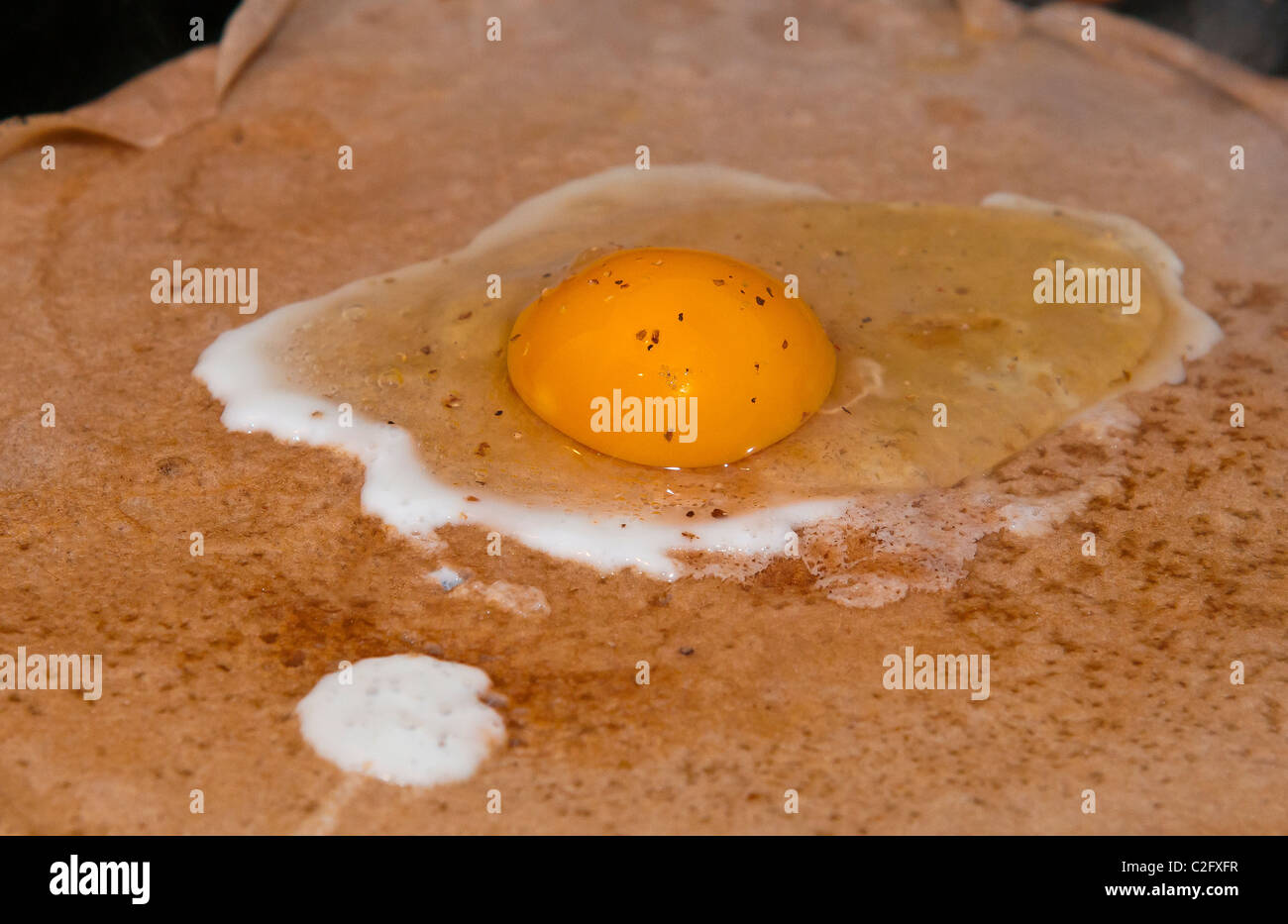A fried egg on crepe Stock Photo
