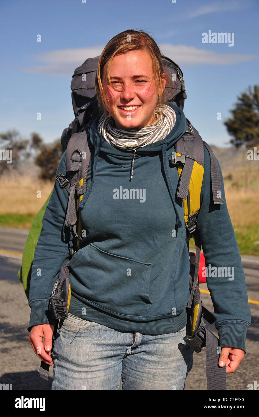 Young female hitchhiker, near Culverden, Canterbury Region, South Island, New Zealand Stock Photo