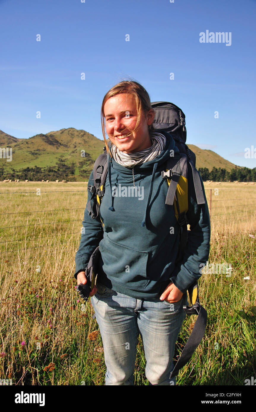 Young female hitchhiker, near Culverden, Canterbury Region, South Island, New Zealand Stock Photo